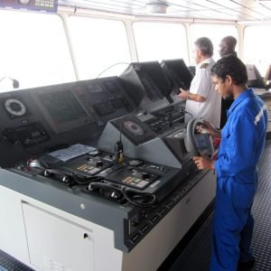 Helmsman during pilotage on the navigational bridge of the ship
